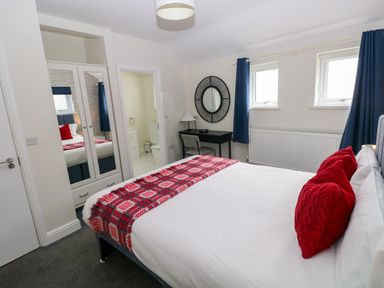 A bedroom with a bed and bedside table at Teifi Villa in St Dogmaels