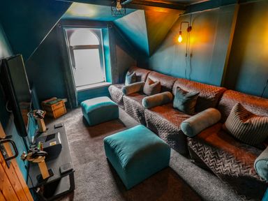 A snug with a sofa and television at Teifi Villa in St Dogmaels