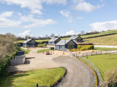 A rural area with four modern houses on gravel and grass surrounded by fields at Eagles Peak in Allerton near Thornton-Le-Dale
