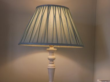 A table lamp with a pleated lampshade on a wooden base at Rose Cottage in Faceby near Swainby