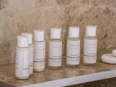 Bottles of shampoo and conditioner on a bathroom shelf at Rose Cottage in Faceby near Swainby