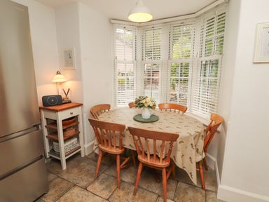 A dining room with a table and chairs at The Old Post House at Low Stott Park near Newby Bridge