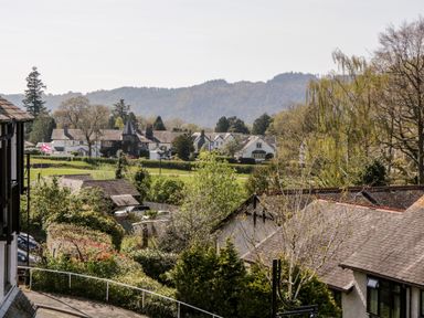 A neighborhood with houses trees and hills in the background at Claife Heights in Windermere