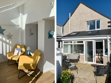 A sitting area with two yellow chairs and small table inside a room and an exterior view of a two-story house with patio furniture and open glass door at Malltraeth Cottage in Malltraeth