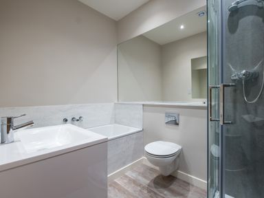 A bathroom with a sink bathtub toilet and shower at Howe Keld 4 First floor in Keswick