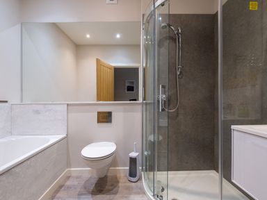 A bathroom with a bathtub toilet shower and sink at Howe Keld 5 First Floor in Keswick
