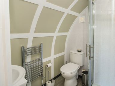 A bathroom with a toilet shower enclosure sink and wall-mounted towel radiator at Cherry Pod in Hookagate near Meole Brace