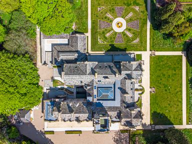 An aerial view of a large building surrounded by gardens and pathways at The Mabel Suite Stone Cross Mansion in Ulverston