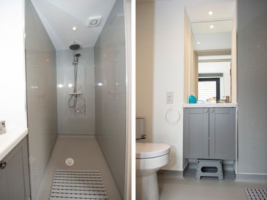 A bathroom with a shower area on the left and a toilet with a sink cabinet and mirror on the right at Owl Lodge in Wedmore
