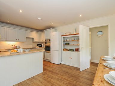 A kitchen with cabinets and countertops at Samphire in Rock