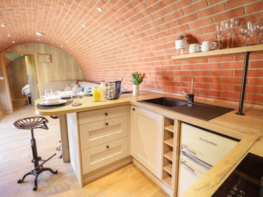 A kitchen with a wooden countertop and brick arched ceiling at Nant yr Esgair Mallwyd near Dinas Mawddwy
