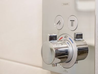A close up of a chrome shower control panel with temperature and water flow settings at The Annexe in Llanfairpwllgwyngyll