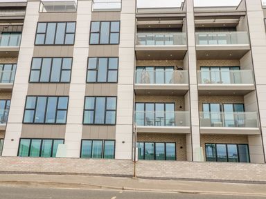 Exterior view of a modern apartment building with balconies and large windows at 30 Cliff Edge in Newquay