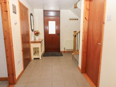 A hallway with a front door and a table at Summerseat in Kirkby Stephen