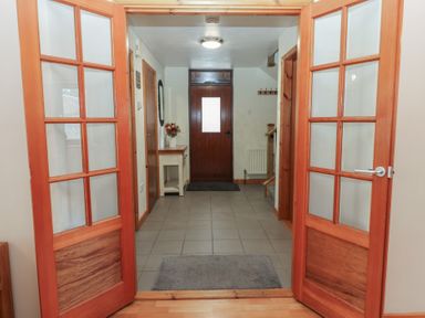 A hallway with double doors and a console table at Summerseat in Kirkby Stephen