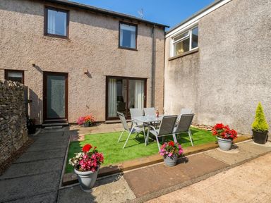 A garden area with a table and chairs at Summerseat in Kirkby Stephen