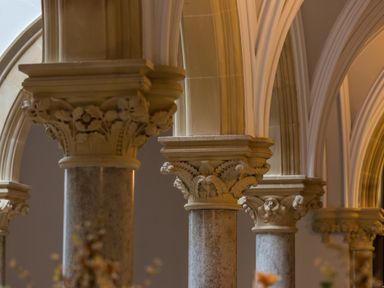Decorative stone columns with ornate capitals supporting arches at The Elizabeth Suite Stone Cross Mansion in Ulverston