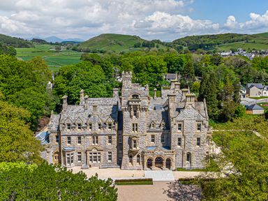 A large stone mansion surrounded by trees and hills at The Elizabeth Suite Stone Cross Mansion in Ulverston