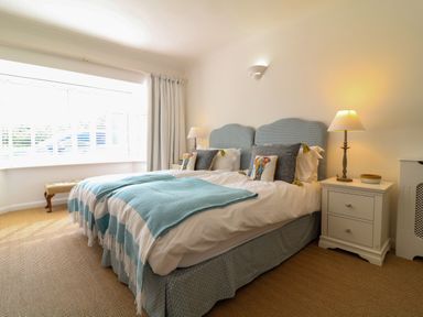 A bedroom with two single beds bedside tables and lamps at Alpha in St Minver