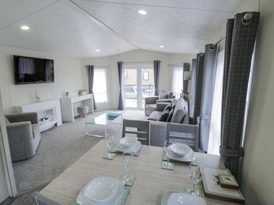 A living room with a dining table and sofa at Serendipity