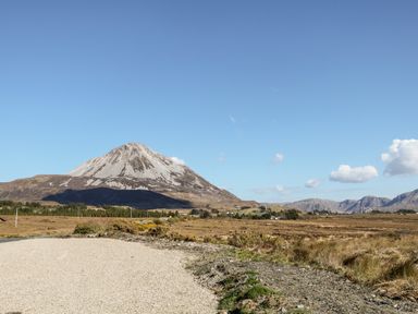 A mountain with rocky terrain under a clear blue sky in a rural area at Wisteria Cottage in Annagry County Donegal