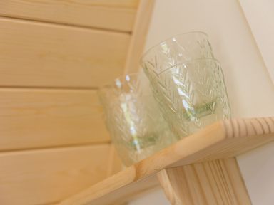 Two patterned glass cups on a wooden shelf in a kitchen at Green Fields in St Buryan