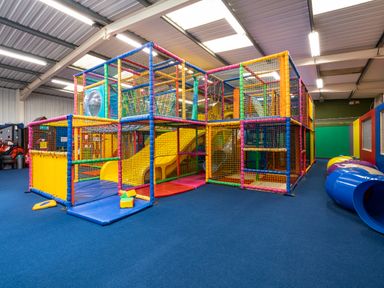 An indoor play area with a multi-level soft play structure and slides at Ridges Retreat No 7 Kigbeare Lodges Ashbury Resort near Fowley Cross Sourton Down and Okehampton