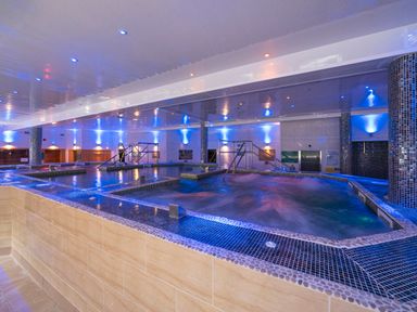 An indoor swimming pool area with tiled edges and metal handrails at Ridge's Retreat No 7 Kigbeare Lodges Ashbury Resort near Fowley Cross Sourton Down and Okehampton