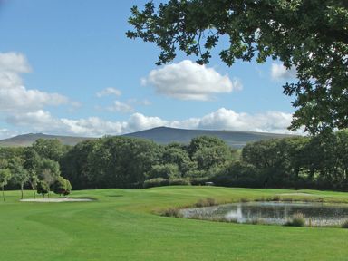 A golf course with a sand bunker a pond trees and hills in the background at Ridges Retreat No 7 Kigbeare Lodges Ashbury Resort near Fowley Cross Sourton Down and Okehampton