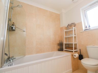 A bathroom with a bathtub and toilet at Trelowen St Issey near Padstow