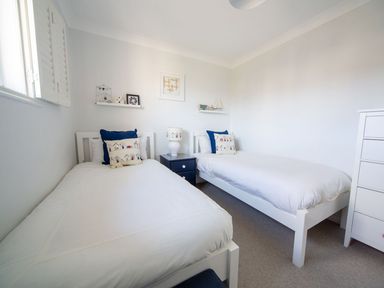 A bedroom with two beds and a nightstand at Trelowen St Issey near Padstow