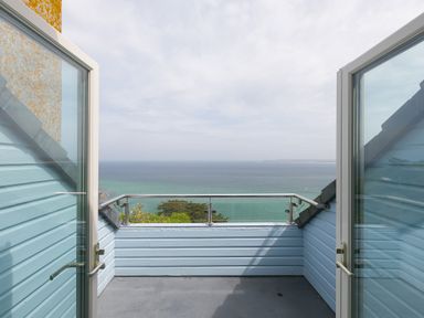 A balcony with glass doors and a view of the sea at Moonbeams in Carbis Bay