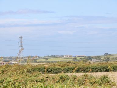 A rural landscape with green fields trees and power lines at Awelfryn Elim near Llanddeusant