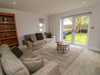 A living room with a sofa and coffee table at Wyvill House in Cayton