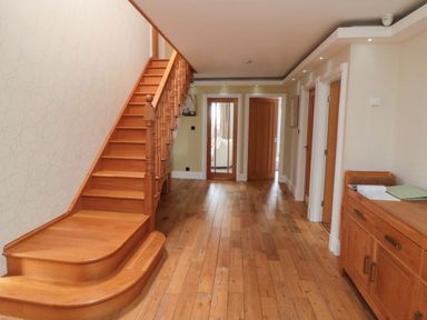 A hallway with stairs and doors at Wyvill House in Cayton