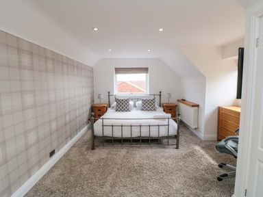A bedroom with a bed and side tables at Wyvill House in Cayton