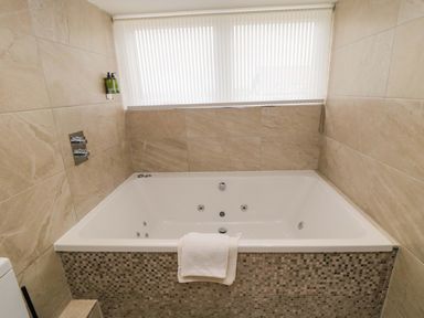 A hot tub with a towel beside it at Wyvill House in Cayton
