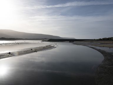 A coastal scene with water channels sandbanks and hills in the background at Harbour View Flat 2 in Barmouth