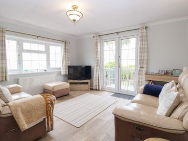 A living room with a sofa and television at Seaward in Trimingham