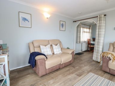 A living room with chairs and a table at Seaward in Trimingham
