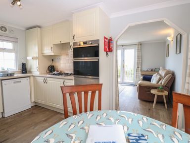 A kitchen with a table and chairs at Seaward in Trimingham
