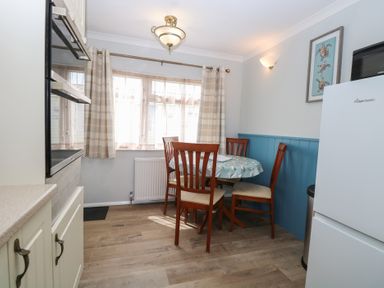 A kitchen with a dining table and chairs at Seaward in Trimingham