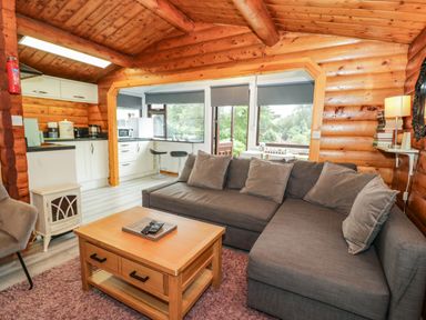 A living room with a sofa and coffee table at Babbling Brook in Bron Aber near Blaenau Ffestiniog