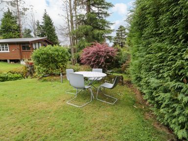 A table with chairs in a garden at Babbling Brook in Bron Aber near Blaenau Ffestiniog