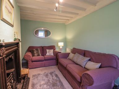 A living room with two sofas and a lamp at Preswylfa in Ffestiniog
