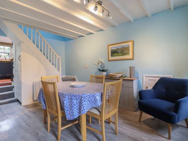 A dining room with a table and chairs at Preswylfa in Ffestiniog