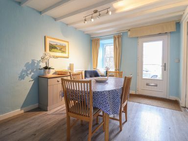 A dining room with a table and chairs at Preswylfa in Ffestiniog