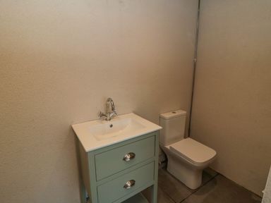 A bathroom with a sink vanity and a toilet at Nightingales in Bridlington