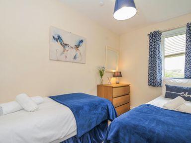 A bedroom with two beds and a dresser at Hideaway Cottage St Ann's Chapel Cornwall