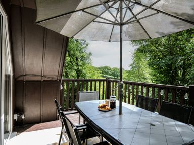 An outdoor dining area with a table and chairs at Hideaway Cottage St Ann's Chapel, Cornwall